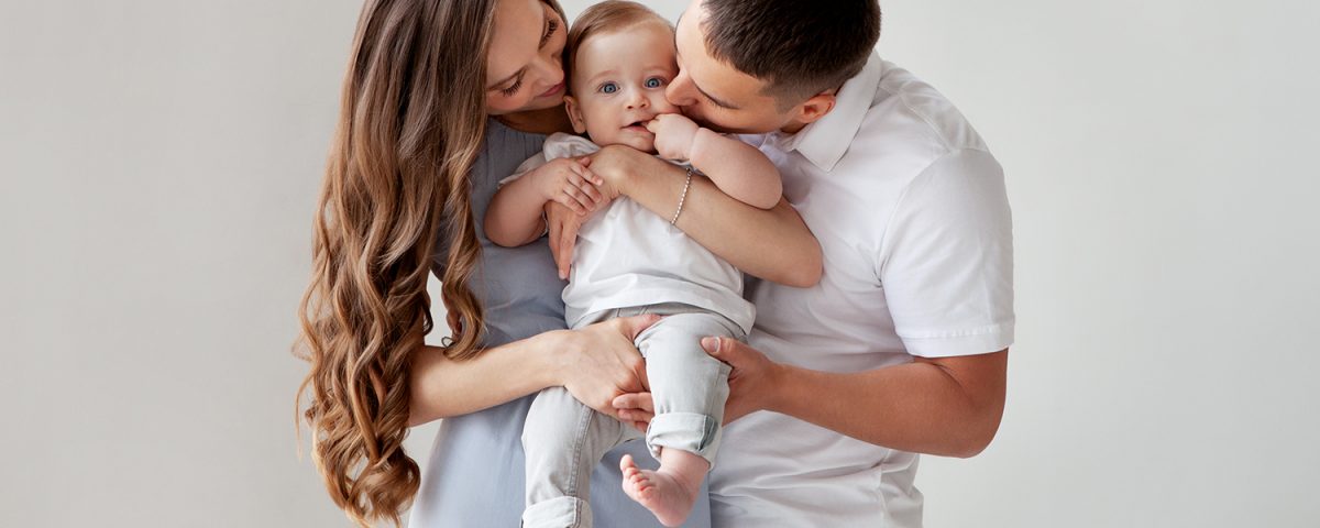 Happy young couple with a baby created via IVF and surrogacy