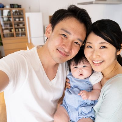 Asian parents with their baby born via surrogacy and IVF